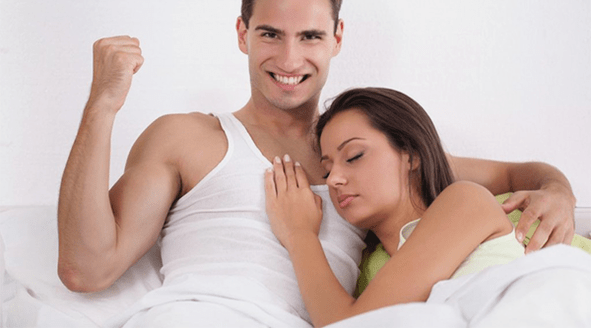 a woman in bed with a man who increased his potency